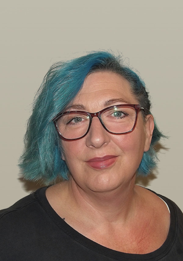 Debbie, a woman with blue hair and glasses, wearing a black shirt.
