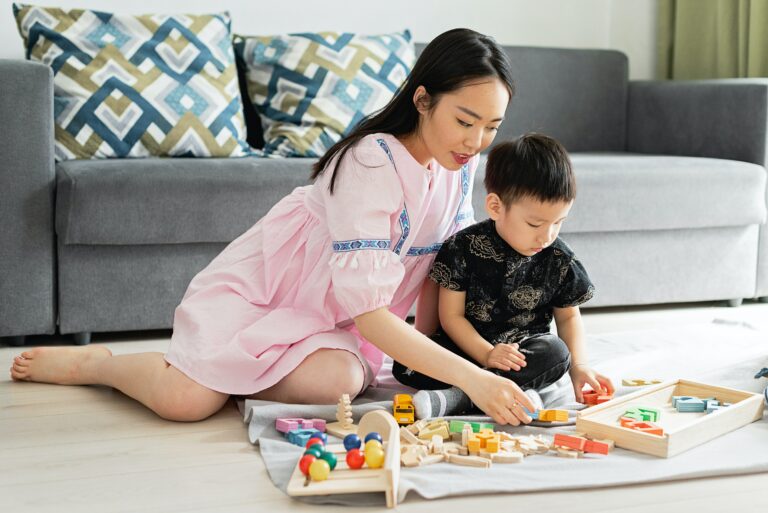 A mother and son using the Proloquo AAC program in the living room.